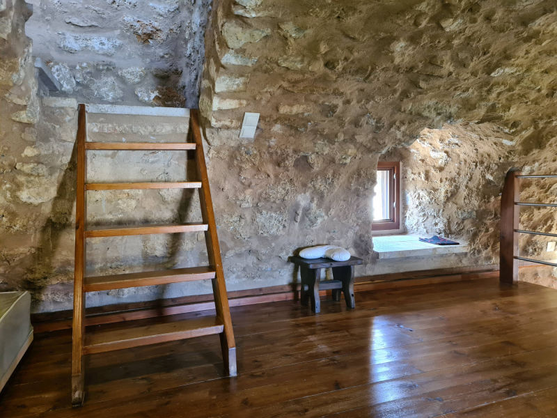 Vacation home PYRGOS 1869 - The attic with stair case to the upper bedroom
